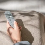 Hình ảnh cận cảnh tay cầm điều khiển Google TV Streamer với thiết kế cải tiến và nút âm lượng được đặt lại vị trí thuận tiện hơn.