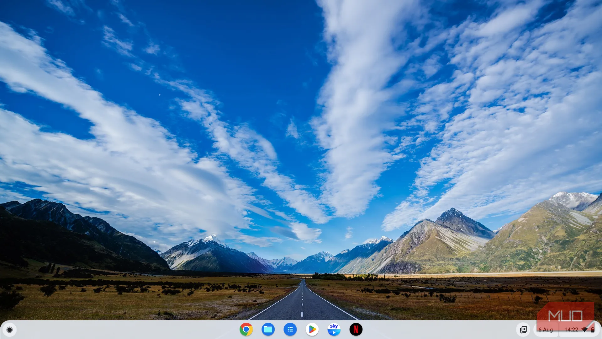 Màn hình chính đơn giản của ChromeOS với hình nền phong cảnh và thanh dock ứng dụng tiện lợi.
