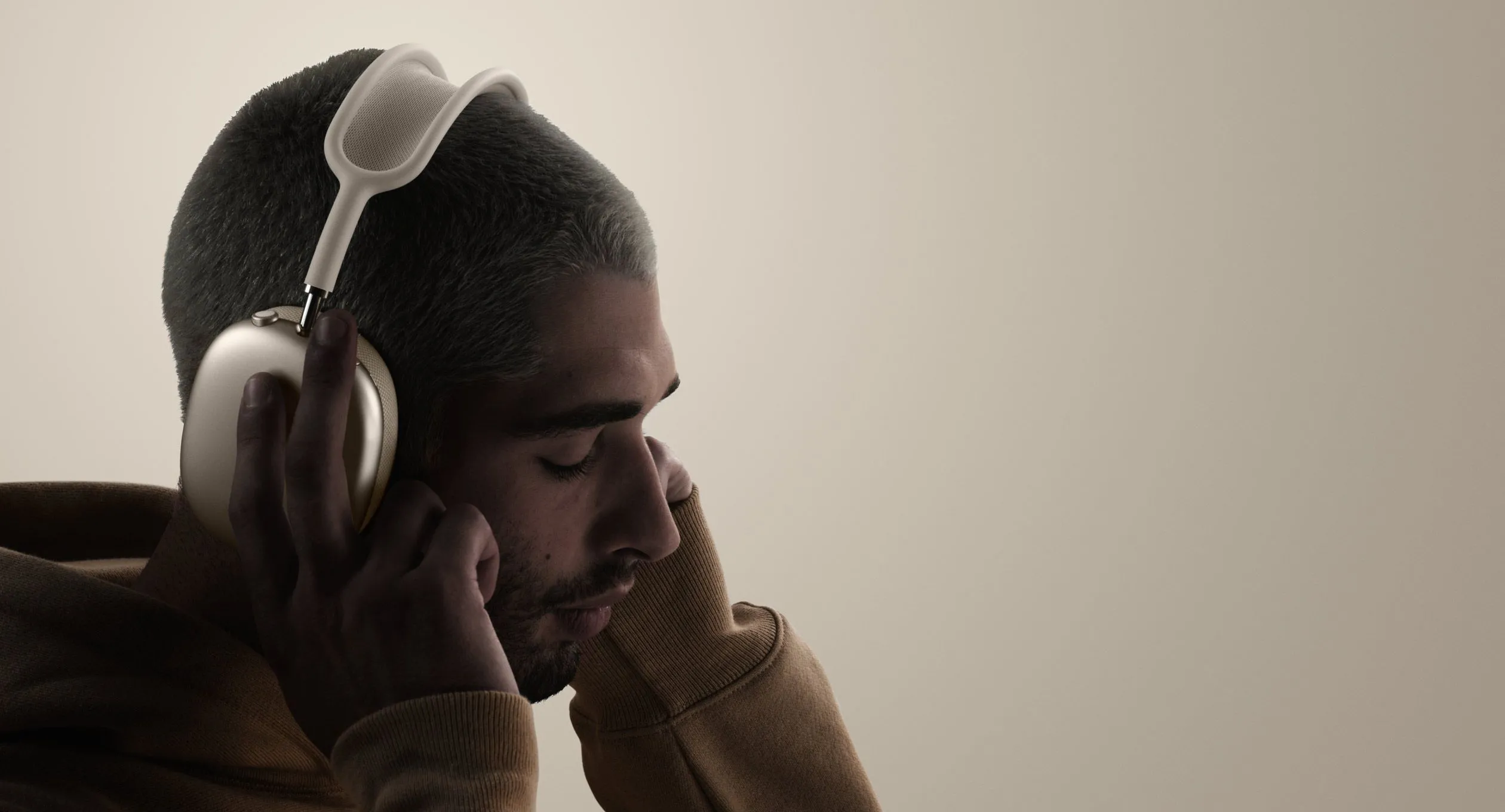 Một người đang đeo tai nghe AirPods Max, cho thấy kích thước và vẻ ngoài sang trọng nhưng cũng tiềm ẩn vấn đề về trọng lượng