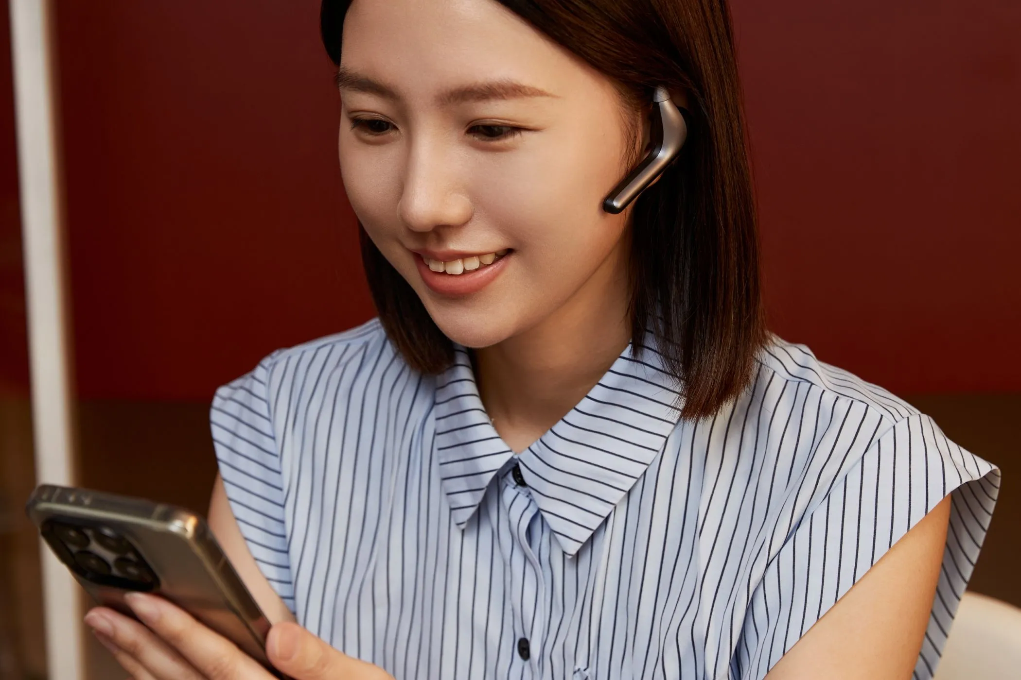 Một phụ nữ trẻ đang thực hiện cuộc gọi video, đeo tai nghe W4 Pro, trải nghiệm dịch thuật mượt mà nhờ AI tự hoàn thiện của Babel OS