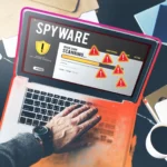Người dùng laptop thực hiện quét phần mềm gián điệp và phần mềm độc hại, hiển thị các biểu tượng cảnh báo