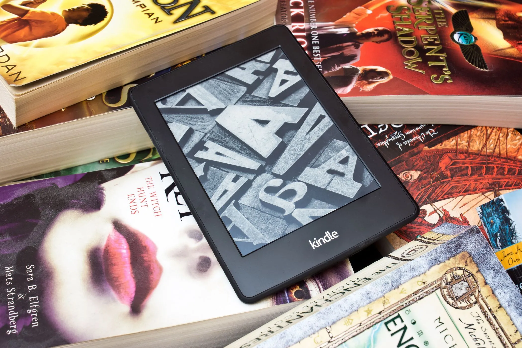 Thiết bị Kindle trên nền sách vật lý, biểu trưng cho quyền sở hữu và quản lý sách điện tử